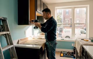 Handyman removing old kitchen cabinet