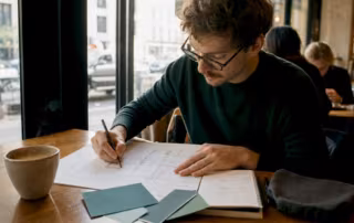 Designer sketching kitchen layout at desk