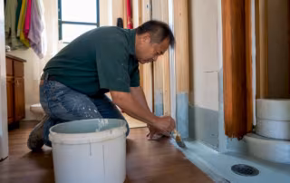 Man applying mortar preparing bathroom floor