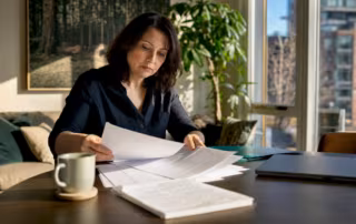 Homeowner reviewing contractor documents at table